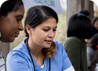 Photo of an HCP working as part of a local clinic to reduce spread of COVID-19 in the community.