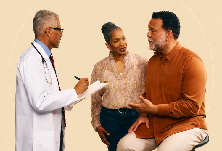Photo of a young African-American doctor discussing COVID-19 signs and symptoms with an older African-American man and his wife.